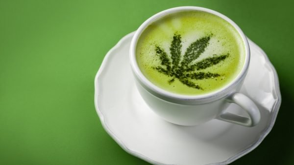 Cannabis matcha tea latte on green background