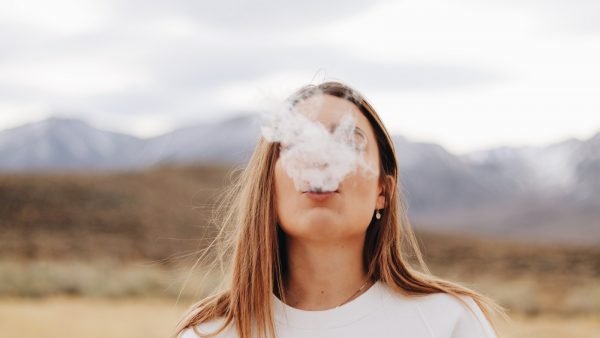 Woman blowing smoke